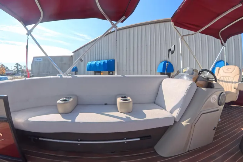 Slide: The Image of 2018 Crest I 220 SLC boat storage compartment with open seat revealing interior components. - 9