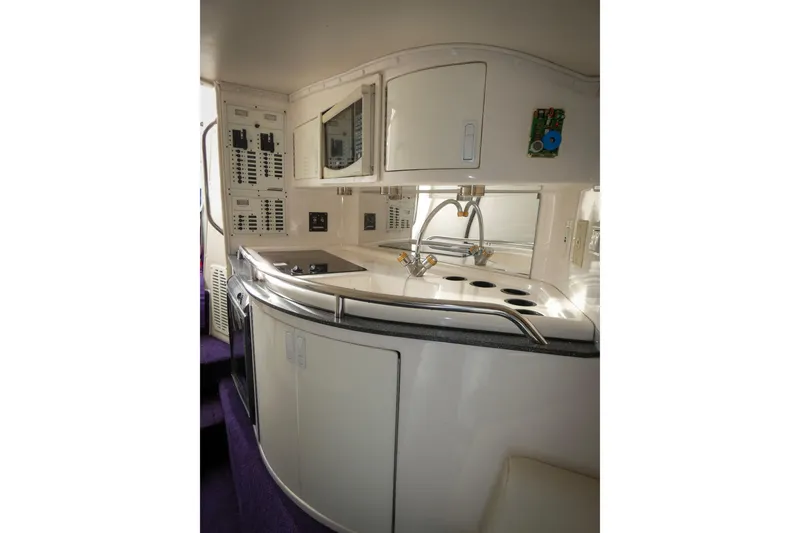 Slide: The Image of 2006 Fountain 47 Lightning yacht interior with modern kitchen and control panels. - 15