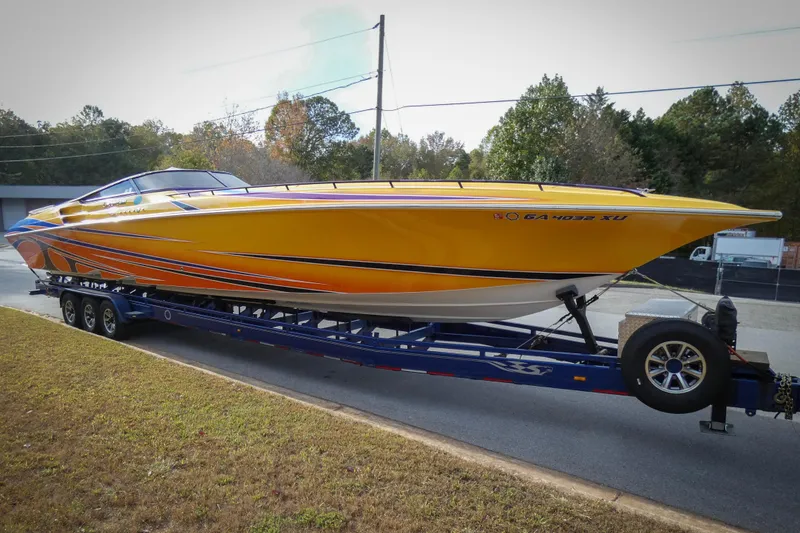 Slide: The Image of 2006 Fountain 47 Lightning speedboat on trailer, vibrant yellow and orange design. - 4