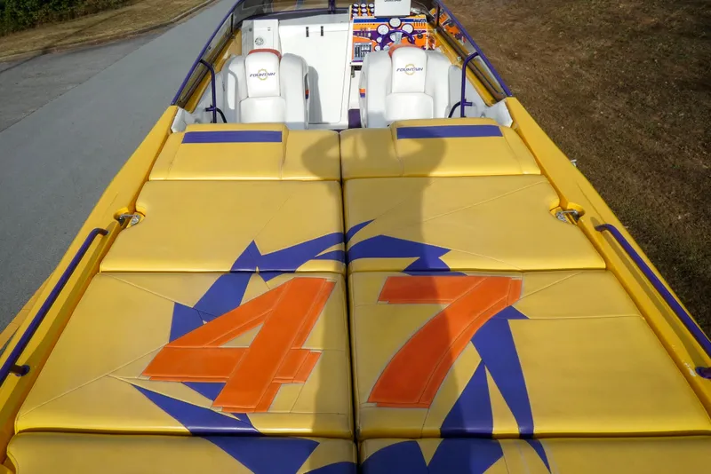 Slide: The Image of 2006 Fountain 47 Lightning boat interior with white seats and colorful dashboard. - 9