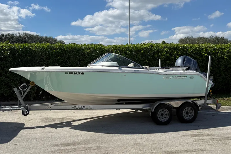The Image of 2023 Key West 203 DFS boat on trailer, parked outdoors under a blue sky. - 0
