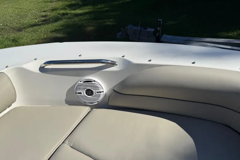 Slide: The Image of 2023 Key West 203 DFS boat interior with cushioned seating and speaker. - 15