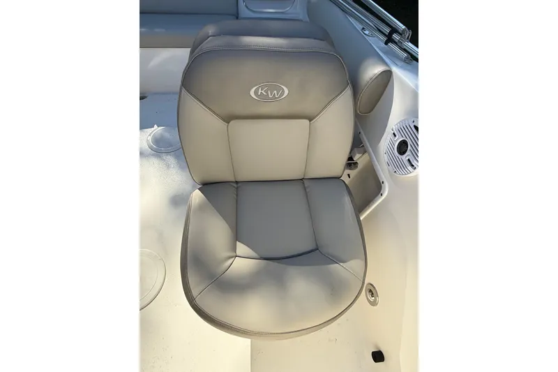 Slide: The Image of 2023 Key West 203 DFS boat seat with KW logo, featuring cup holders and speaker. - 4
