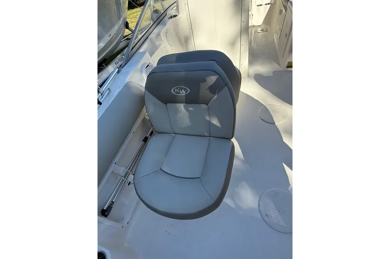 Slide: The Image of 2023 Key West 203 DFS boat seat with gray upholstery and "KW" logo. - 8