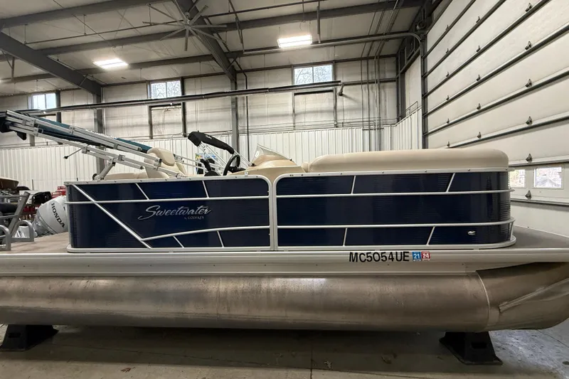 The Image of 2018 Sweetwater SW2086c pontoon boat in a garage setting. - 0
