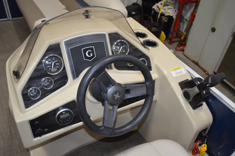 Slide: The Image of Steering console of a 2018 Sweetwater SW2086c boat with gauges and controls. - 10