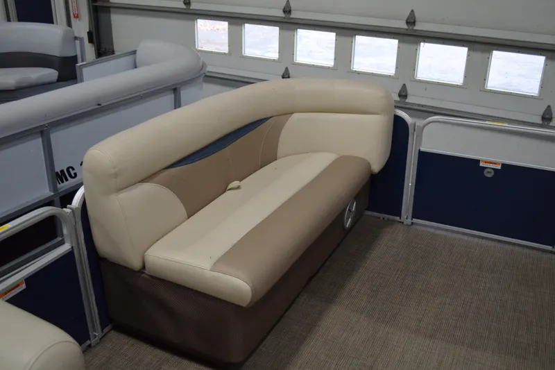 Slide: The Image of 2018 Sweetwater SW2086c pontoon boat interior with beige seating. - 12
