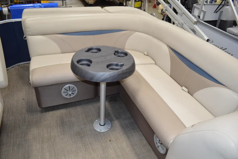 Slide: The Image of 2018 Sweetwater SW2086c boat interior with beige seating and a round table. - 14