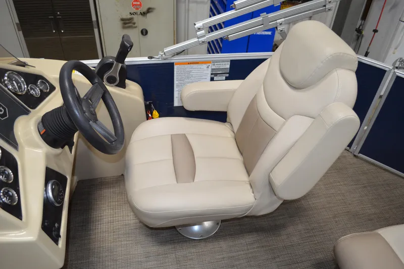Slide: The Image of Captain's chair and dashboard of 2018 Sweetwater SW2086c boat, featuring beige upholstery. - 15
