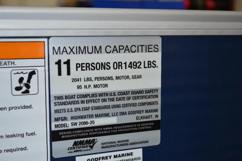 Slide: The Image of Label showing maximum capacity for Sweetwater SW2086c boat: 11 persons or 1492 lbs. - 16