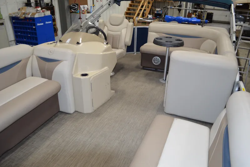Slide: The Image of Interior of a 2018 Sweetwater SW2086c pontoon boat with beige seating and helm. - 17