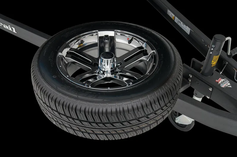 Slide: The Image of Manufacturer Provided Image: Chrome wheel and tire on a 2026 Ranger 212LS trailer, black background. - 25