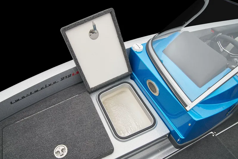 Slide: The Image of Manufacturer Provided Image: 2026 Ranger 212LS boat interior with open storage compartment and blue console. - 33