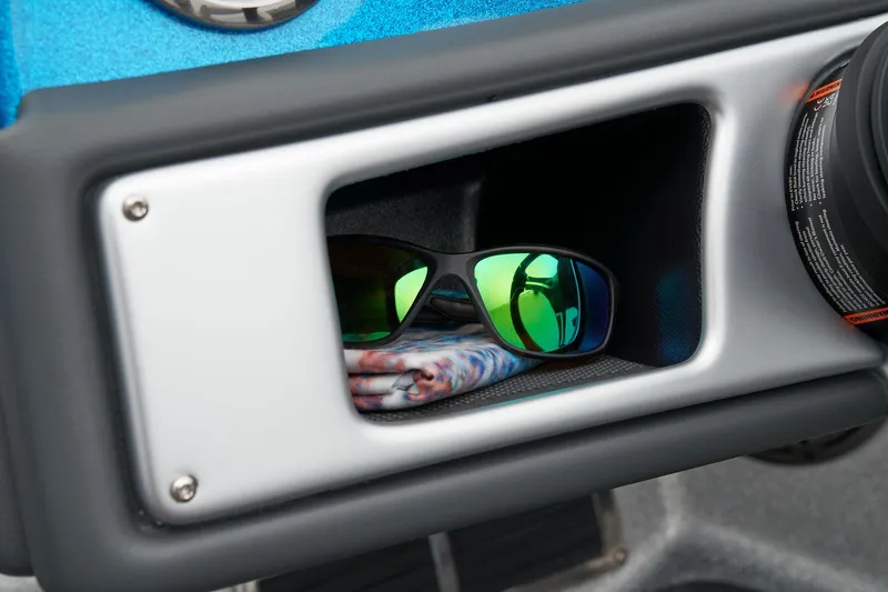 Slide: The Image of Manufacturer Provided Image: Sunglasses in storage compartment of 2026 Ranger 212LS boat dashboard. - 44