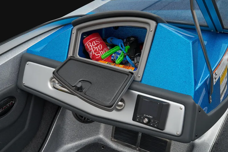 Slide: The Image of Manufacturer Provided Image: 2026 Ranger 212LS boat dashboard with open storage compartment and Bas Pro Shop items. - 49
