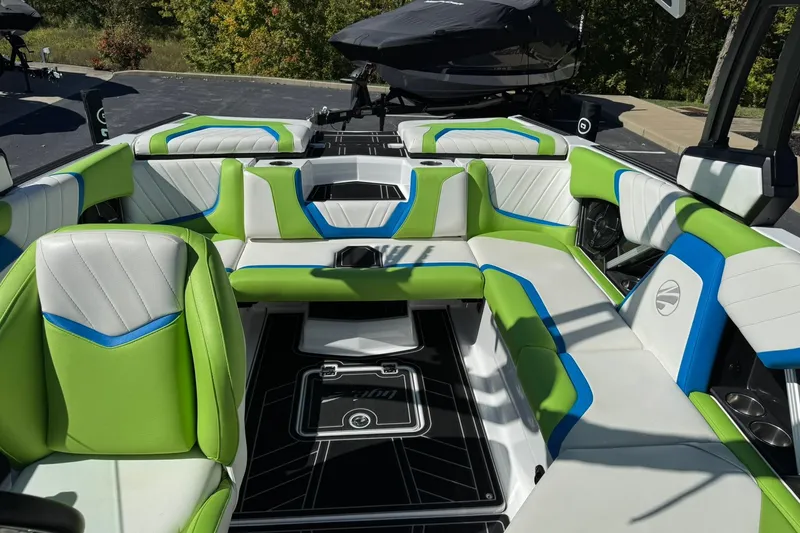 Slide: The Image of 2022 Tigé 20RZX boat interior with vibrant green, blue, and white seating design. - 11