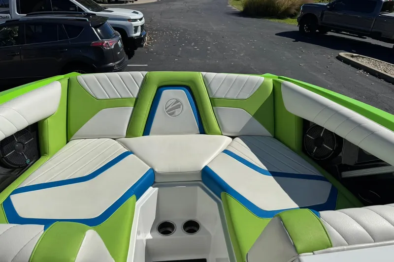 Slide: The Image of 2022 Tigé 20RZX boat interior with vibrant green, blue, and white seating. - 7