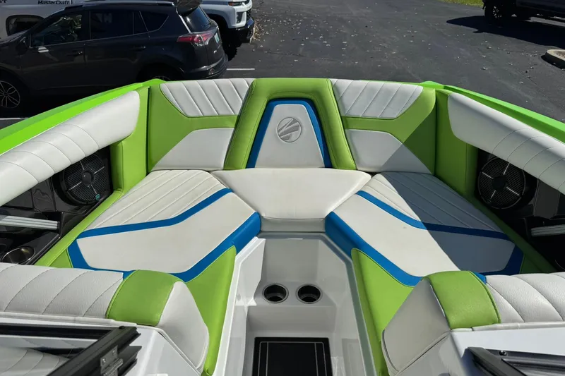 Slide: The Image of 2022 Tigé 20RZX boat interior with vibrant green, blue, and white seating. - 8