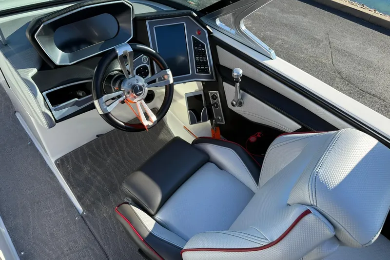 Slide: The Image of 2018 MasterCraft XT21 boat interior with modern steering and dashboard controls. - 12