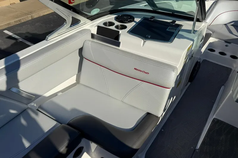 Slide: The Image of 2018 MasterCraft XT21 boat interior with white seating and dashboard. - 13