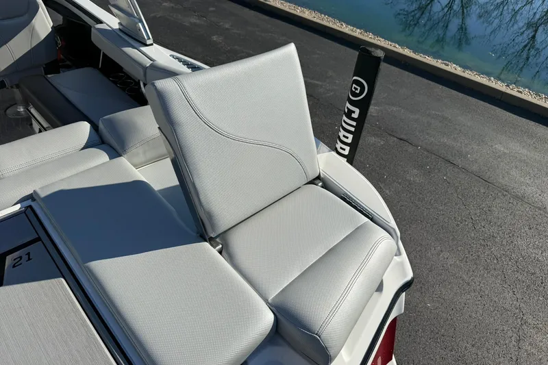 Slide: The Image of 2018 MasterCraft XT21 boat with sleek gray seating and modern design. - 16