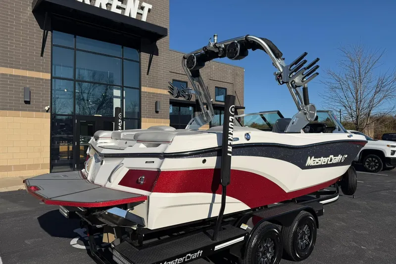 Slide: The Image of 2018 MasterCraft XT21 boat on trailer outside a building, featuring sleek design and vibrant colors. - 3