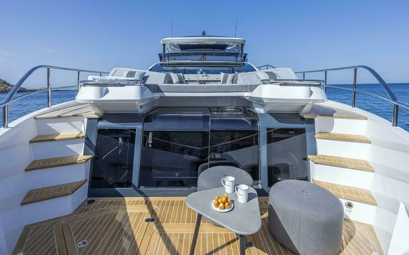 Slide: The Image of Luxurious Pearl 82 yacht deck with seating, table, and ocean view, 2026 model. - 11