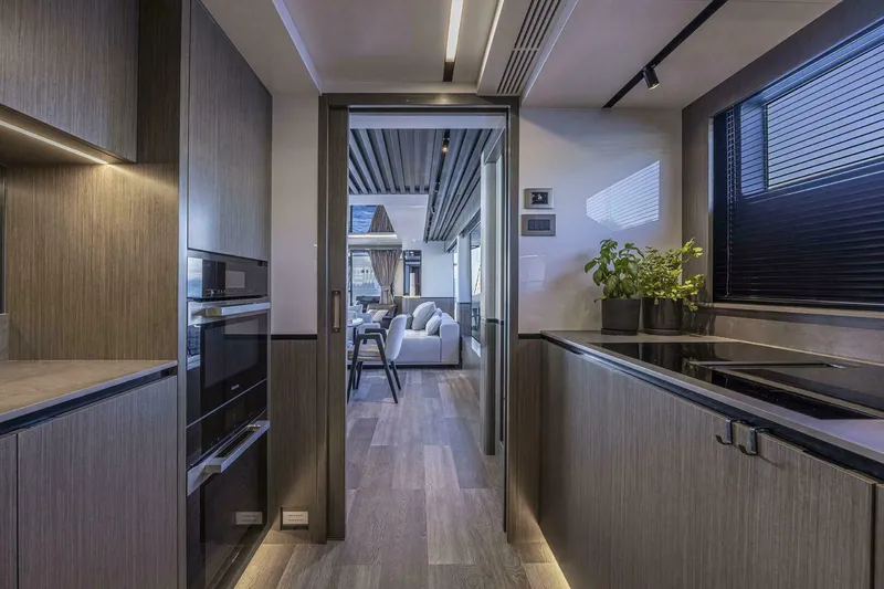 Slide: The Image of Modern kitchen interior on Pearl 82 yacht, featuring sleek cabinetry and contemporary design, 2026 model. - 18
