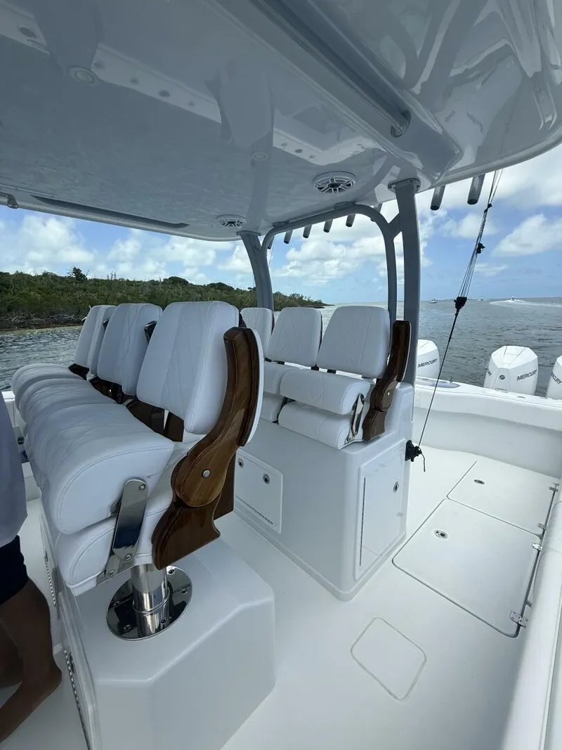 Slide: The Image of Luxurious seating on a 2026 Freeman 38 boat, featuring white cushions and wooden accents. - 12