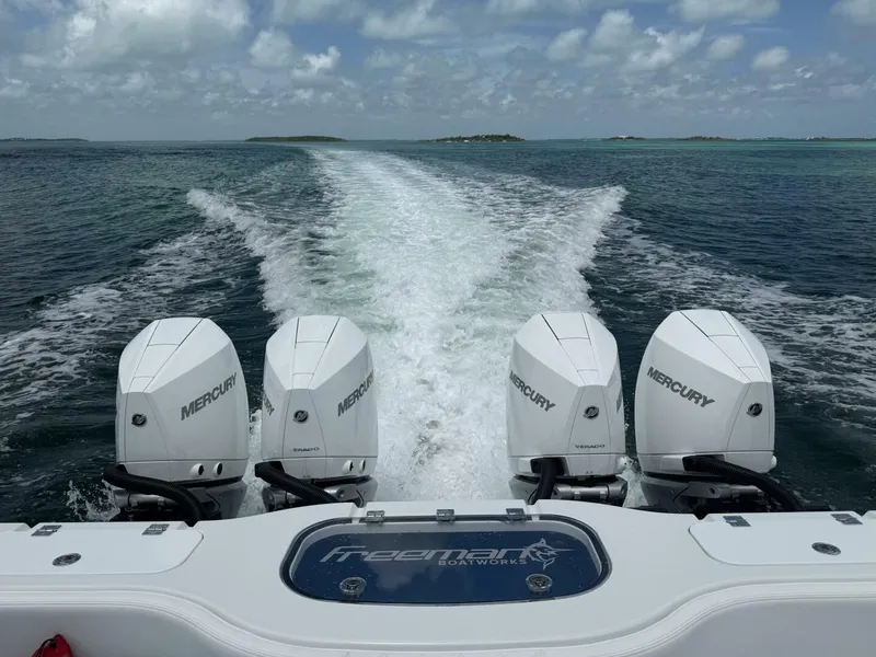 Slide: The Image of Freeman 38 boat with four Mercury engines cruising on open water, 2026 model. - 24