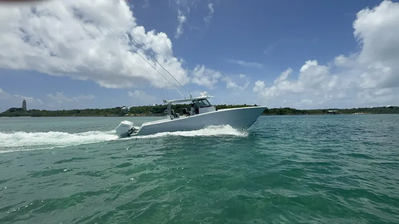 Slide: The Image of 2026 Freeman 38 boat cruising on clear blue water under a partly cloudy sky. - 4