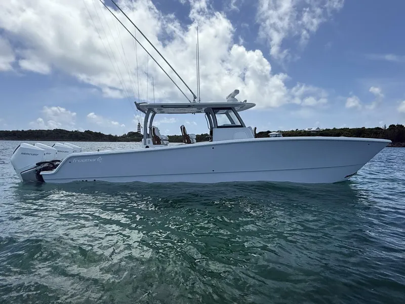 Slide: The Image of 2026 Freeman 38 boat on water under blue sky with clouds. - 6