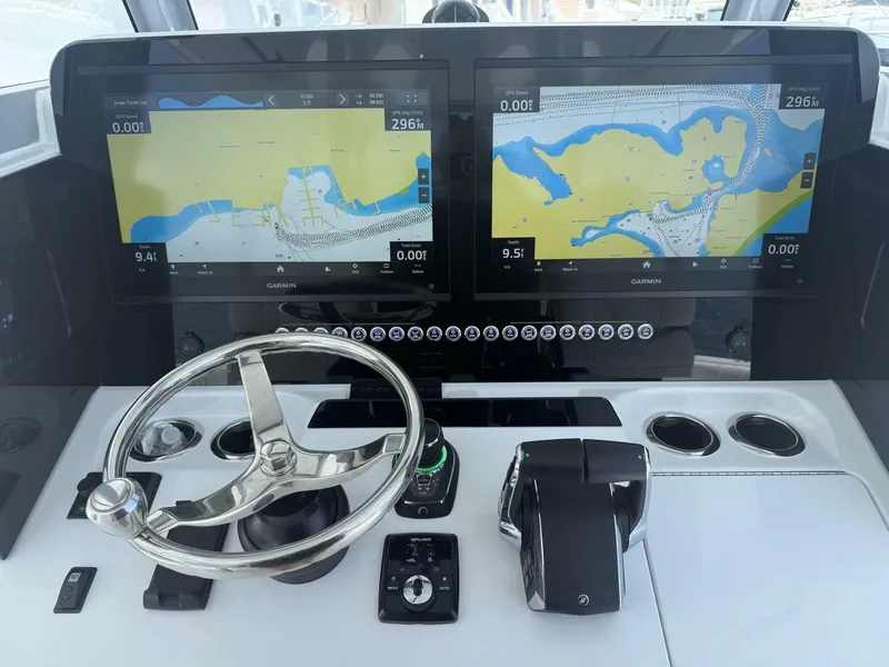 Slide: The Image of Freeman 38 boat dashboard with dual Garmin displays and steering wheel, 2026 model. - 8