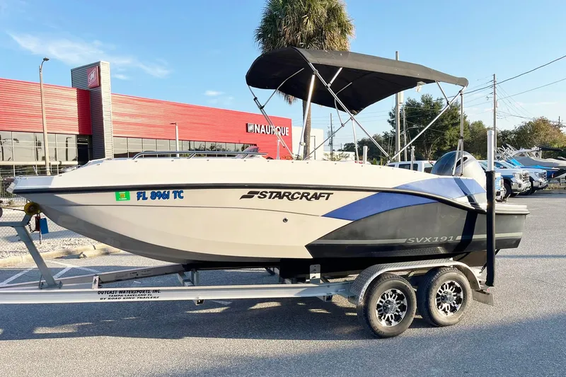 The Image of 2022 Starcraft SVX 191 OB boat on trailer, parked outside dealership. - 0