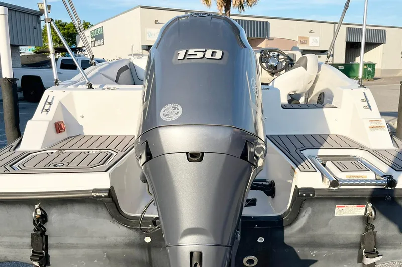 Slide: The Image of 2022 Starcraft SVX 191 OB boat with 150 HP outboard motor, docked in a marina. - 4