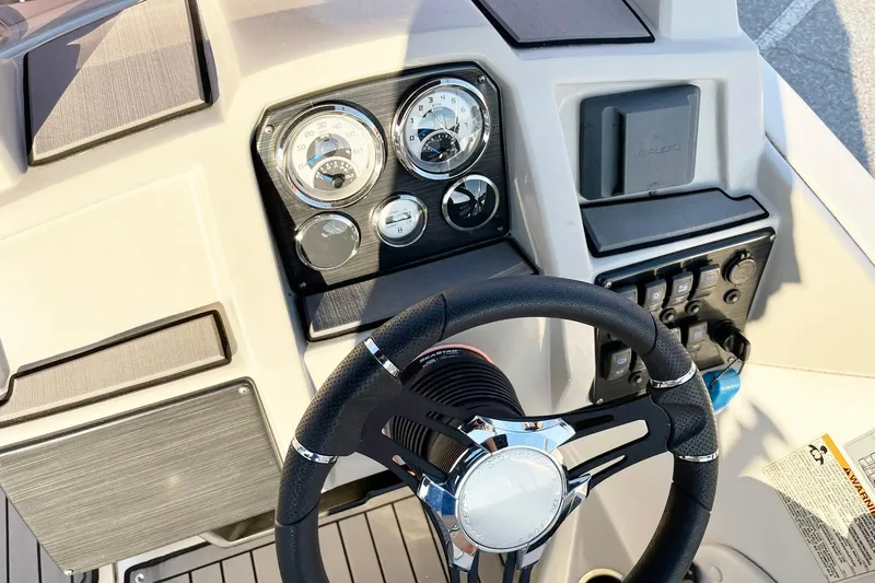 Slide: The Image of 2022 Starcraft SVX 191 OB boat dashboard with steering wheel and gauges. - 5