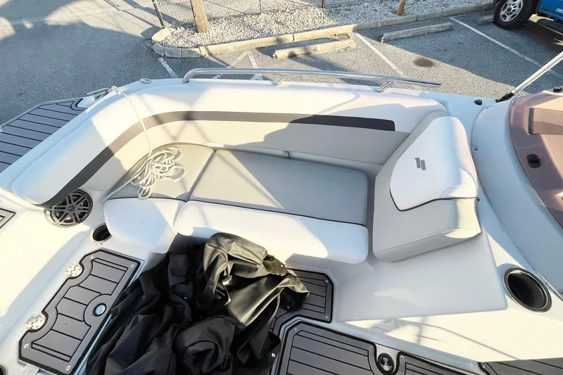 Slide: The Image of 2022 Starcraft SVX 191 OB boat interior with cushioned seating and storage compartments. - 6