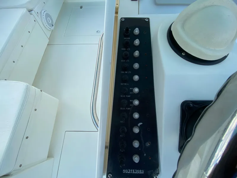 Slide: The Image of 1998 Contender 35 Express boat interior with white cushioned seating and steering wheel. - 20