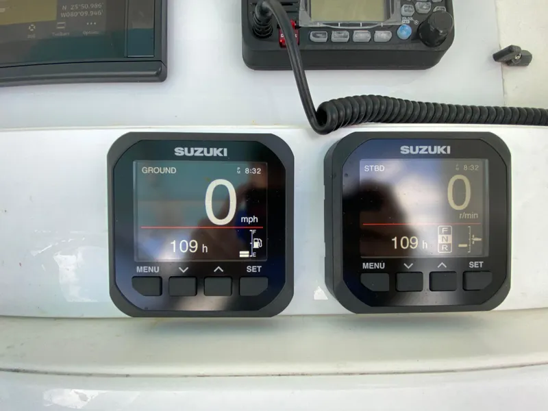 Slide: The Image of 1998 Contender 35 Express boat helm with steering wheel and controls under blue canopy. - 22