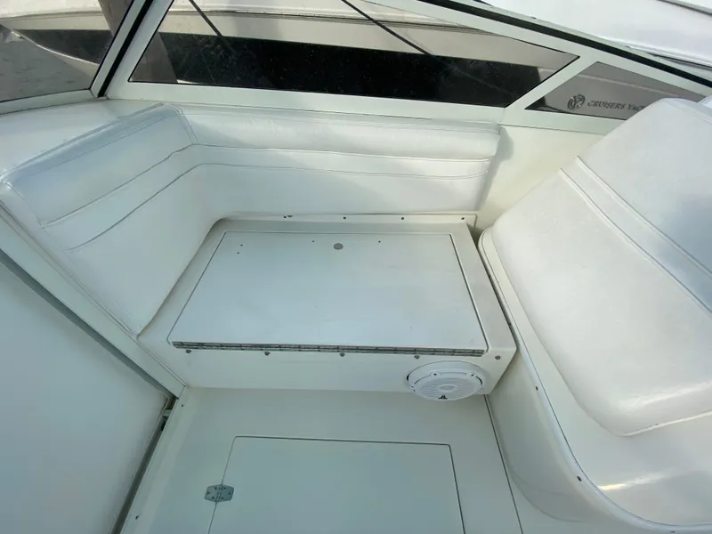 Slide: The Image of 1998 Contender 35 Express boat interior with white seating and steering console. - 32
