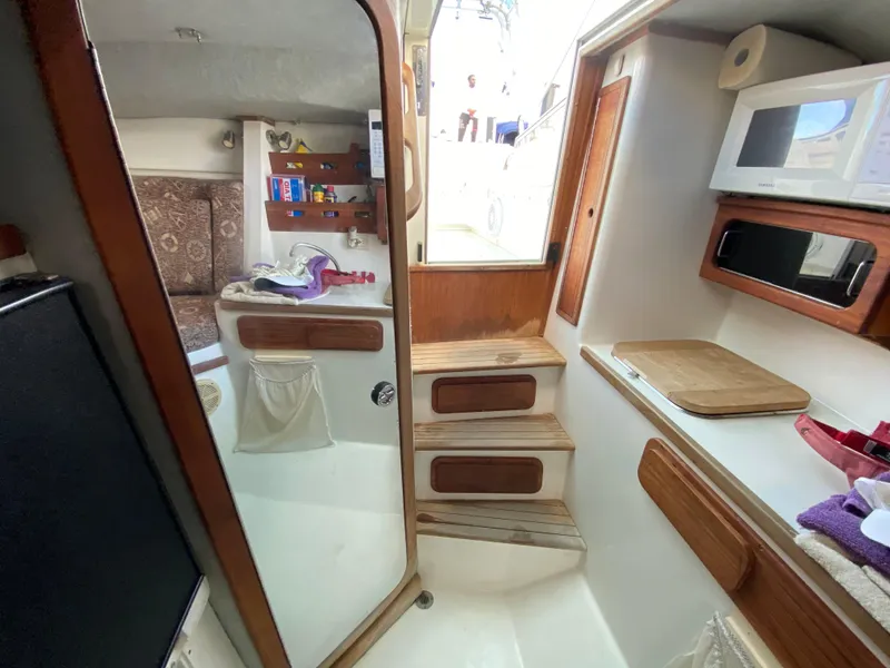 Slide: The Image of 1998 Contender 35 Express boat interior with life jackets in storage compartment. - 42