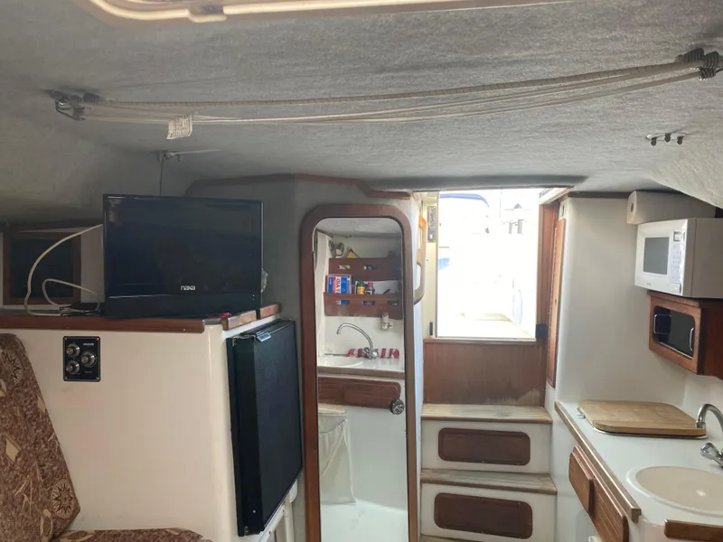 Slide: The Image of 1998 Contender 35 Express cabin with patterned cushions and compact table. - 55