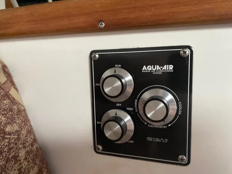 Slide: The Image of Interior cabin of a 1998 Contender 35 Express boat with patterned walls and table. - 56