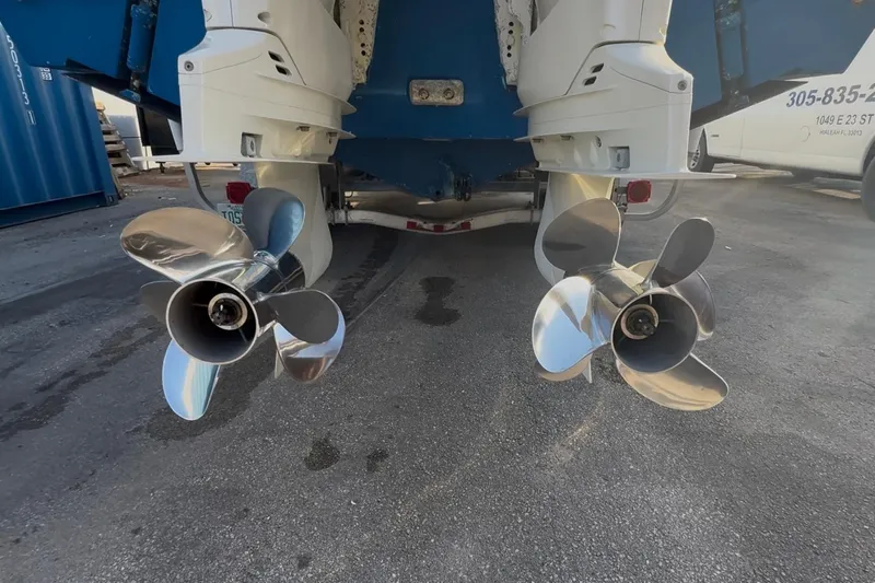 Slide: The Image of Twin propellers of a 1998 Contender 35 Express boat on a trailer. - 93