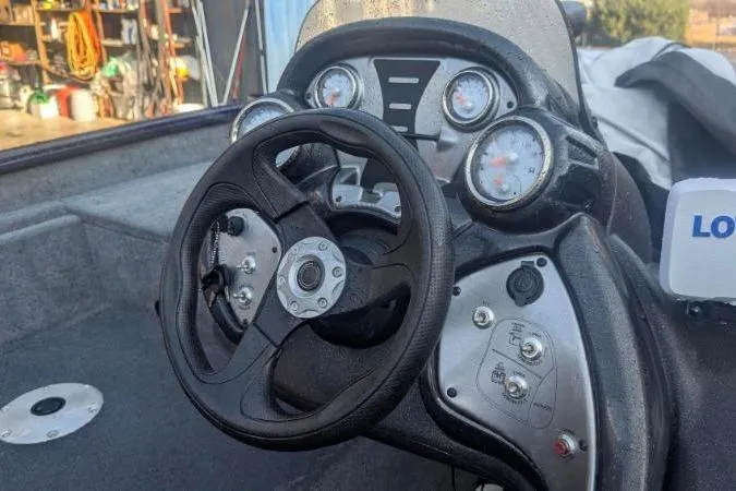 Slide: The Image of Steering console of 2022 Tracker Pro Team 175 TF boat with gauges and controls. - 2