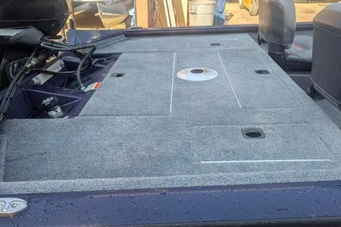 Slide: The Image of 2022 Tracker Pro Team 175 TF boat deck with gray carpeting and storage compartments. - 3