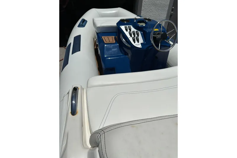 Slide: The Image of 2020 Ribjet 10 boat interior with blue console and steering wheel. - 4
