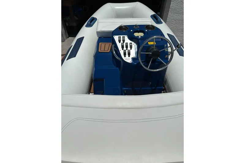Slide: The Image of 2020 Ribjet 10 inflatable boat with blue console and steering wheel. - 7
