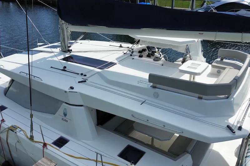 Slide: The Image of 2021 Leopard 45 catamaran with spacious deck and seating area, docked at marina. - 10