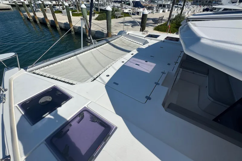 Slide: The Image of 2021 Leopard 45 catamaran deck view at marina, showcasing spacious layout and sleek design. - 103